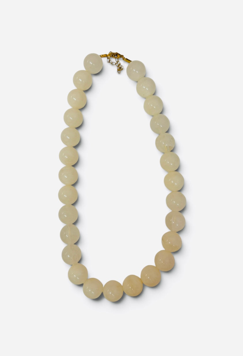 Chunky cream bubble bead necklace with glossy marbled finish and gold-tone clasp.