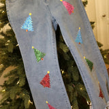 Cropped jeans with multicolor sequin Christmas tree patches and frayed raw hemline.
