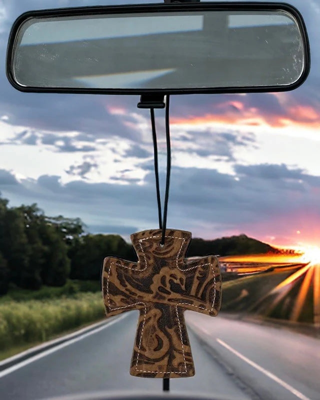 Cross-shaped leather and hair-on-hide reusable car freshener charm designed for re-scenting with oils.