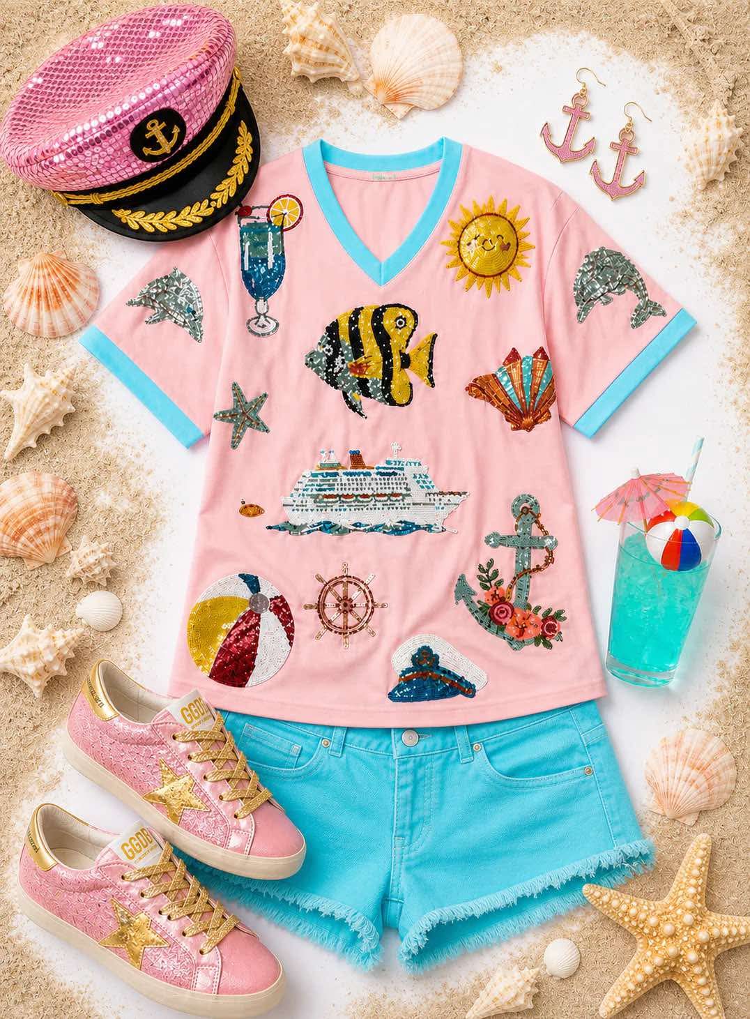 Pink V-neck top with nautical sequin designs and contrasting aqua trim.