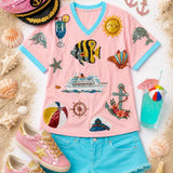 Pink V-neck top with nautical sequin designs and contrasting aqua trim.