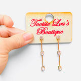 Silver bar drop earrings with three round-cut crystals and polished vertical bars.