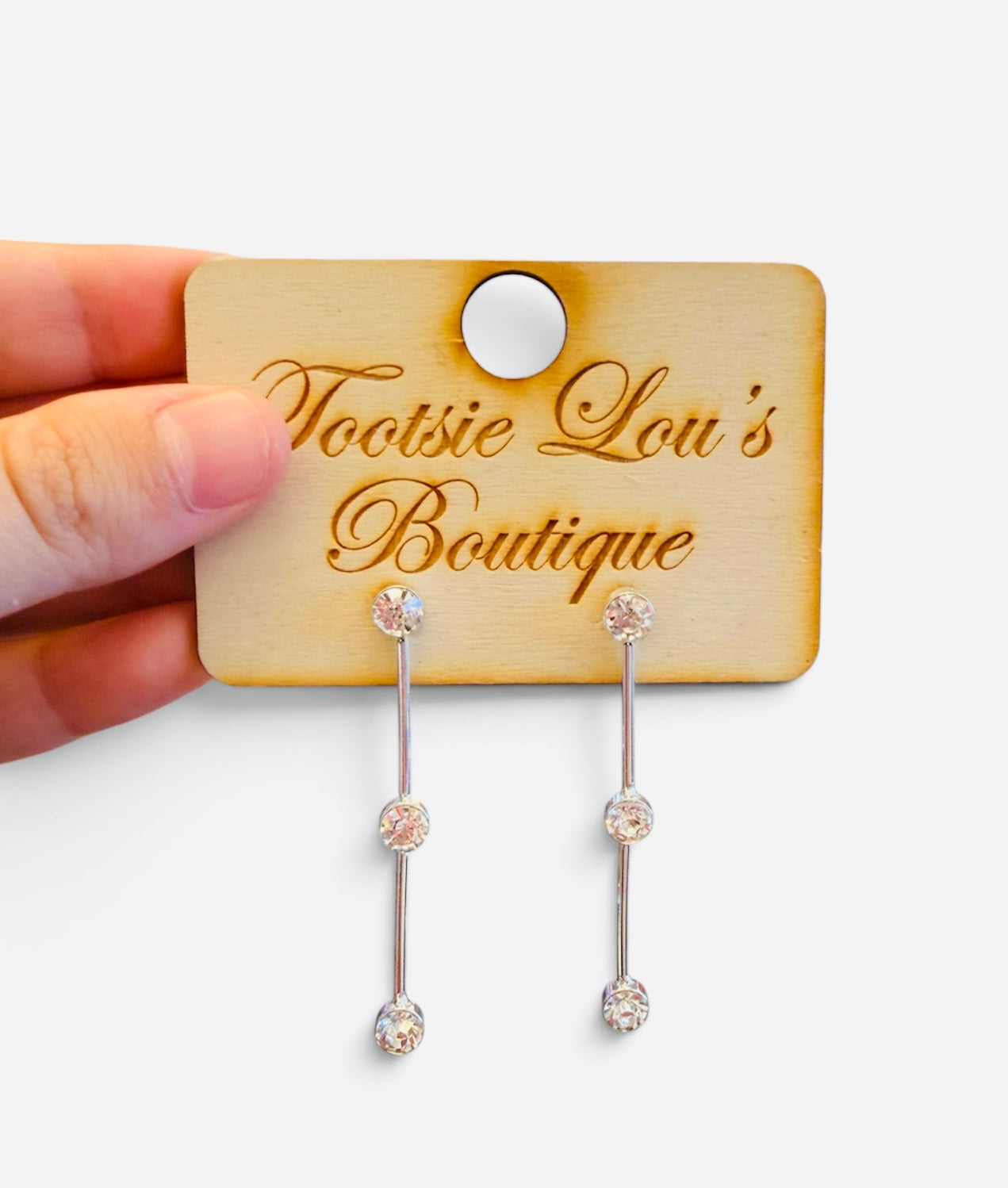 Silver bar drop earrings with three round-cut crystals and polished vertical bars.