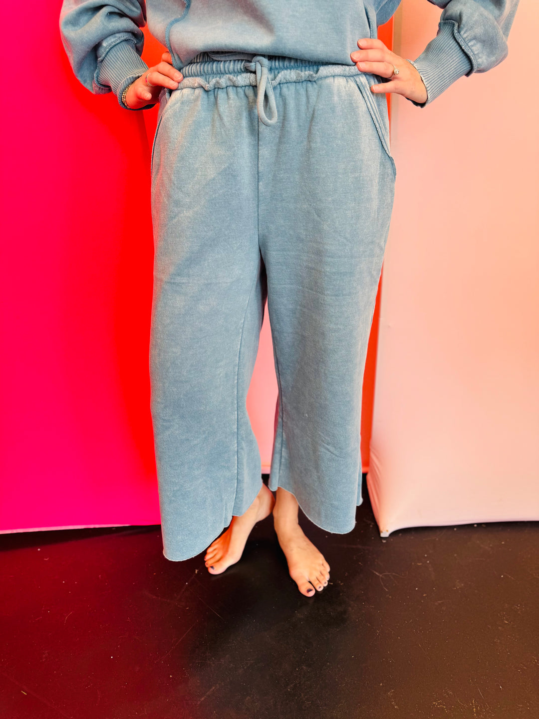 Light teal acid wash French terry sweatshirt with exposed seams and a hi-low hem.