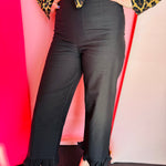 Black high-rise straight-leg pants with subtle ruffled hem and clean back zipper closure.
