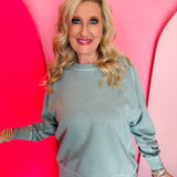 Ash blue French terry long sleeve pullover with contrast stitching and ribbed cuffs.