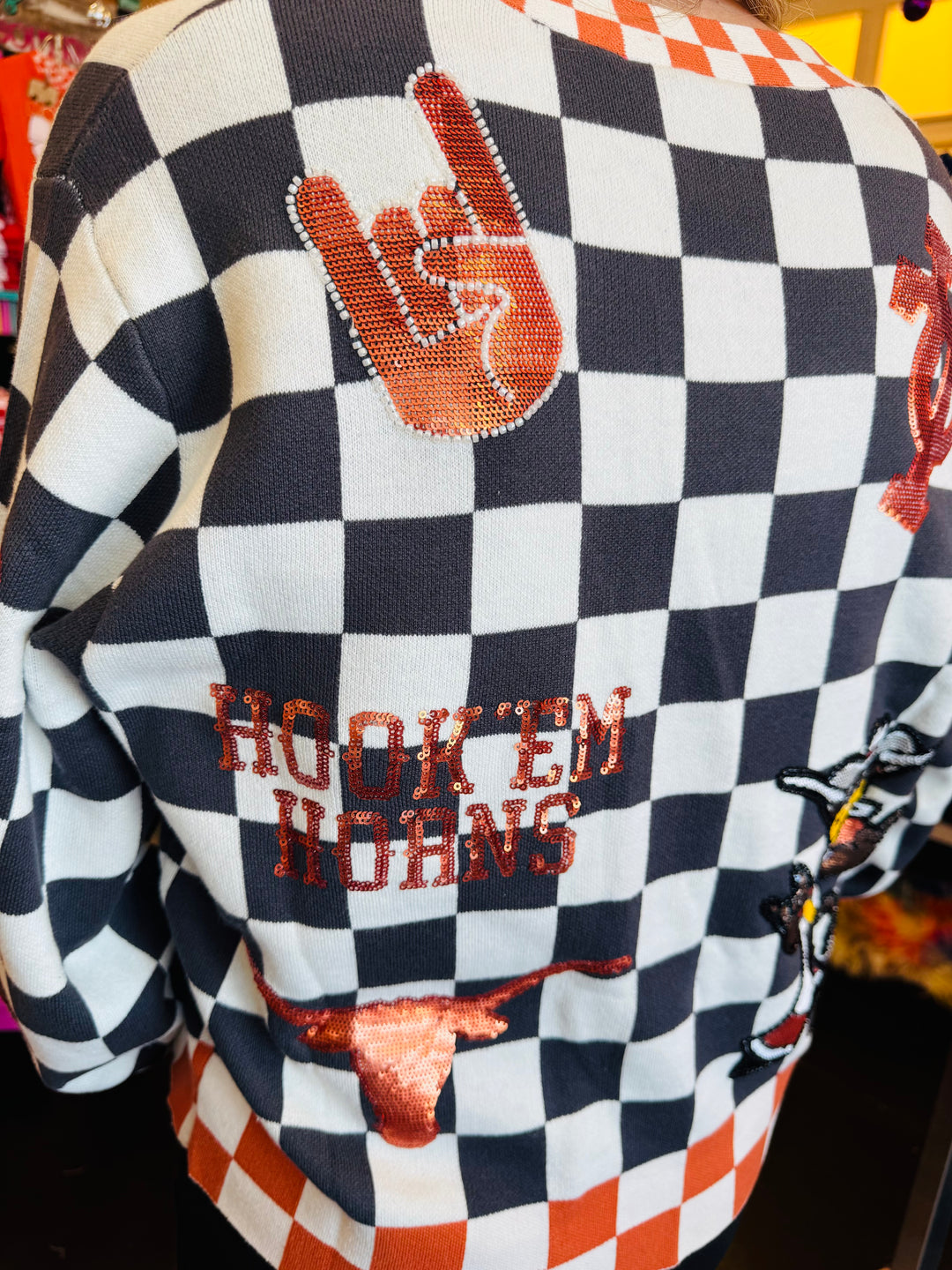 Close up of Queen Of Sparkles checkered University Of Texas  game day sequin cardigan.