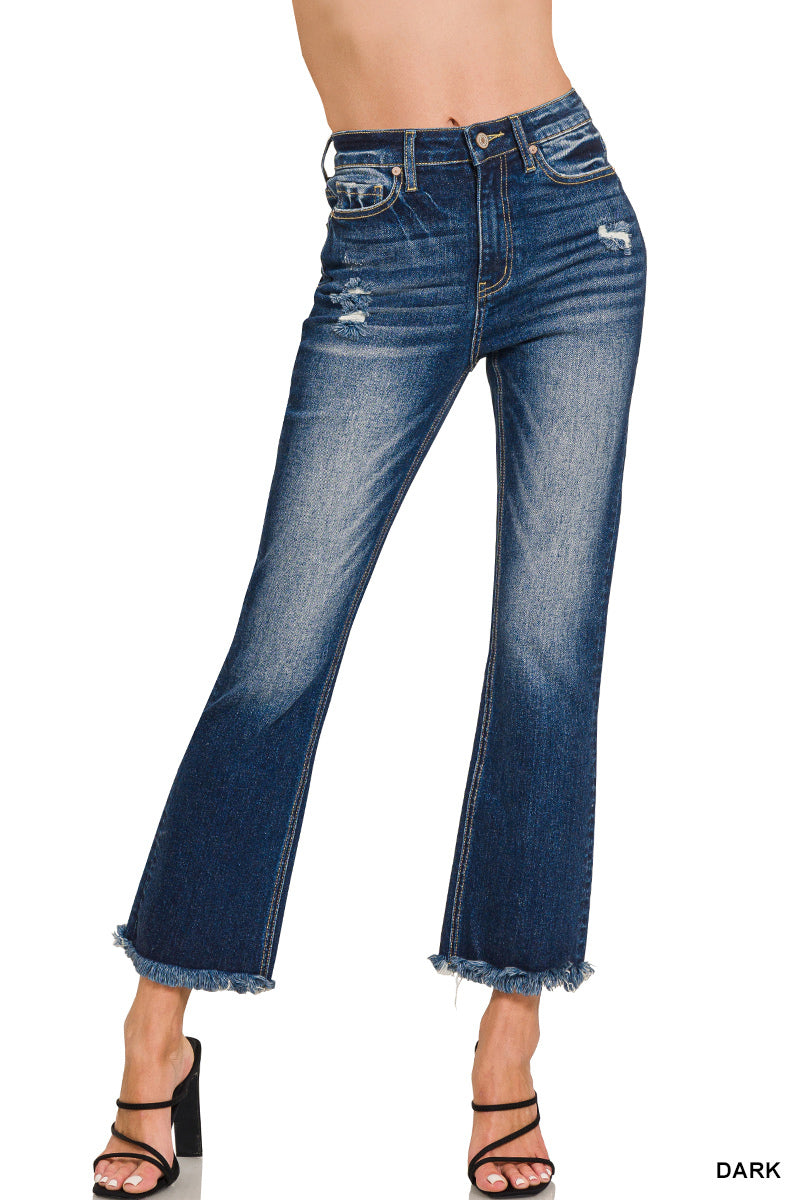 Close view of high-rise cropped denim showcasing raw hem and subtle distressed details