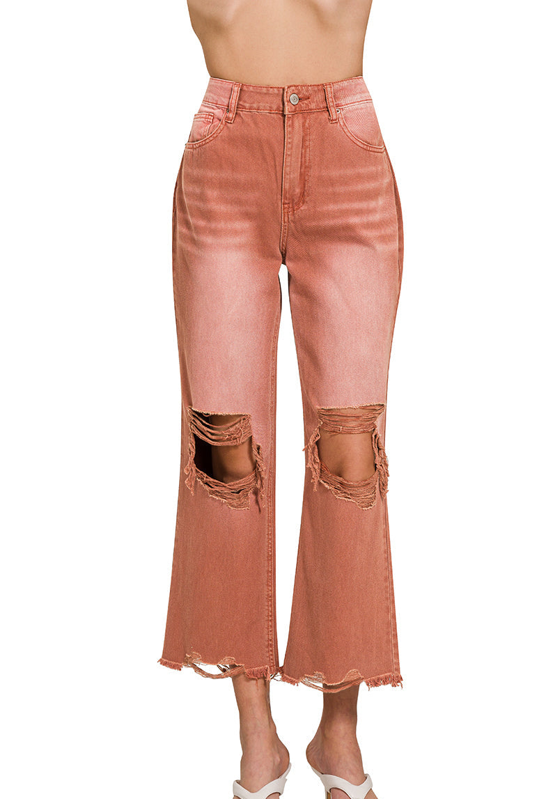 Rust colored distressed knee jeans with raw hemline