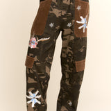 Camo cotton pants with floral embroidery, corduroy patch pockets, and elastic waistband for casual standout style.