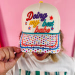 Cream hat with rainbow polka dot bill and colorful Doing My Best Babe embroidery.