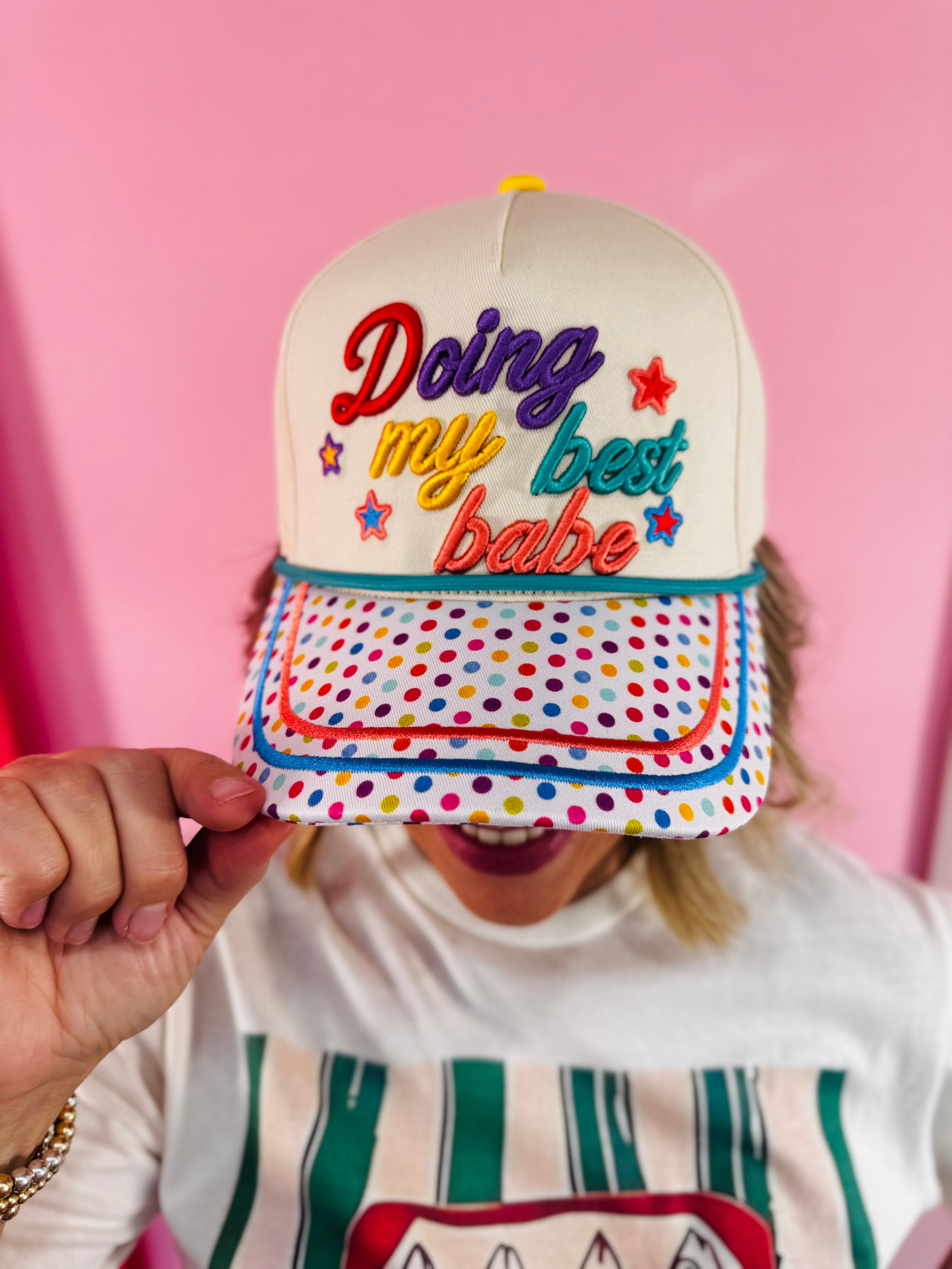 Cream hat with rainbow polka dot bill and colorful Doing My Best Babe embroidery.
