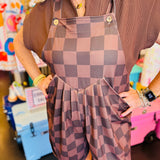 close up of chocolate checkered overall shorts
