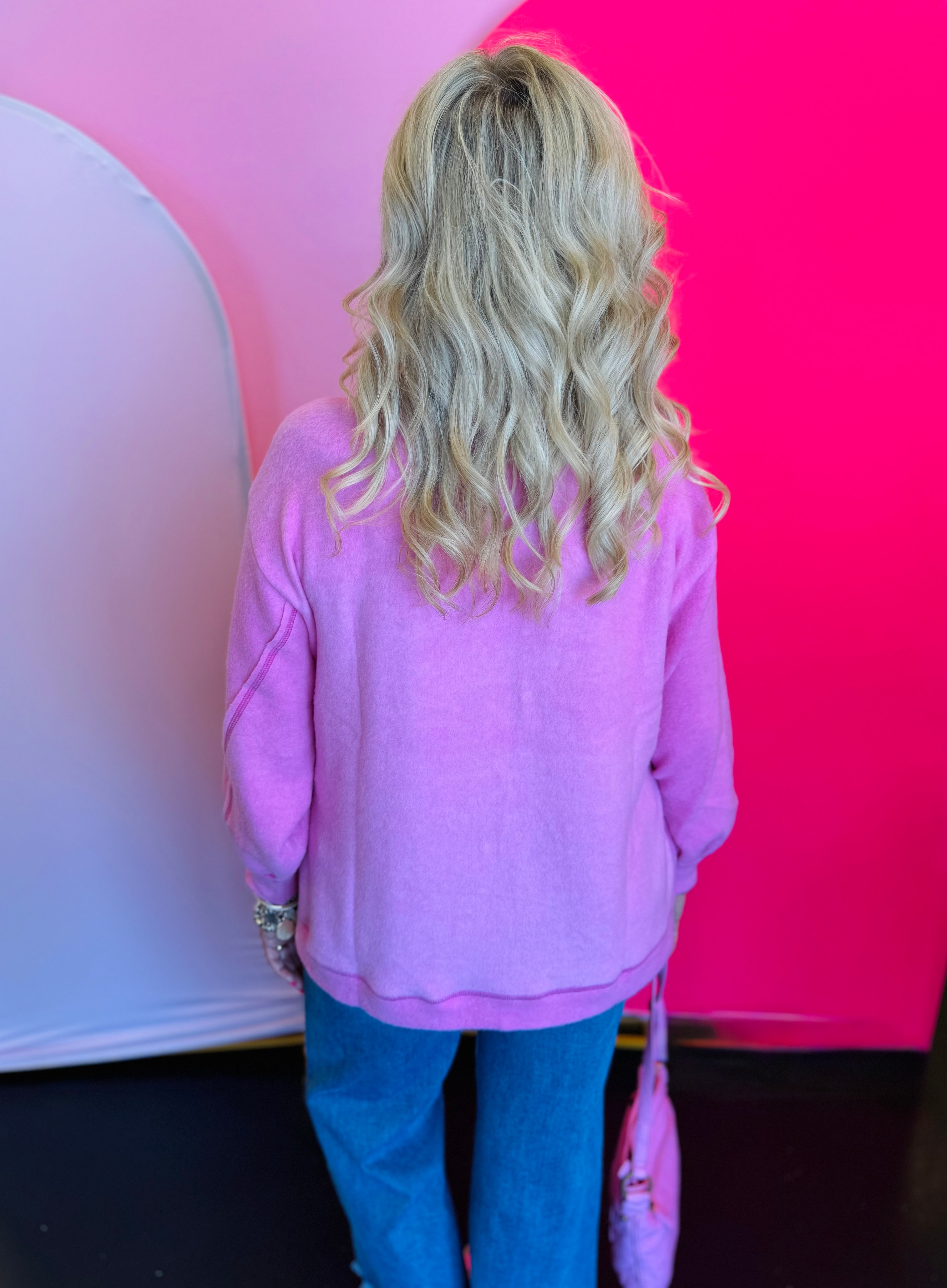 Back view of the sweater displaying the slightly longer hemline and relaxed drape for a comfortable, laid-back fit.
