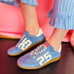 Sky-blue suede Retro 25 sneakers with cream accents, stitched detail, and gum sole.