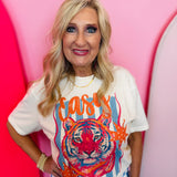 Cream graphic tee with crowned leopard, rhinestone details, and orange and blue artwork.