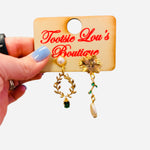 Emerald green mismatch earrings with pearl, gold leaf, and floral sunburst details