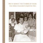 Vintage birthday card with heartfelt message and kraft envelope on recycled paper.