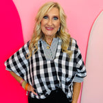 Black and white gingham top with striped collar, rolled sleeves, and hi-low hem.