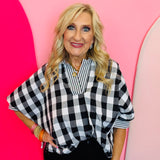 Black and white gingham top with striped collar, rolled sleeves, and hi-low hem.