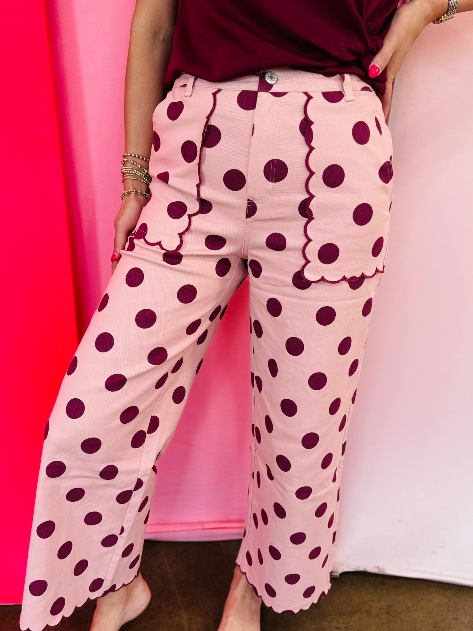 Pink polka dot pants with embroidered scalloped pockets and hem.