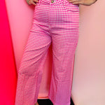 Pink gingham straight leg pants with pockets and button front closure.