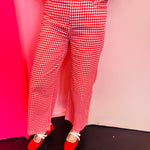 Red gingham straight leg pants with pockets and button front closure.