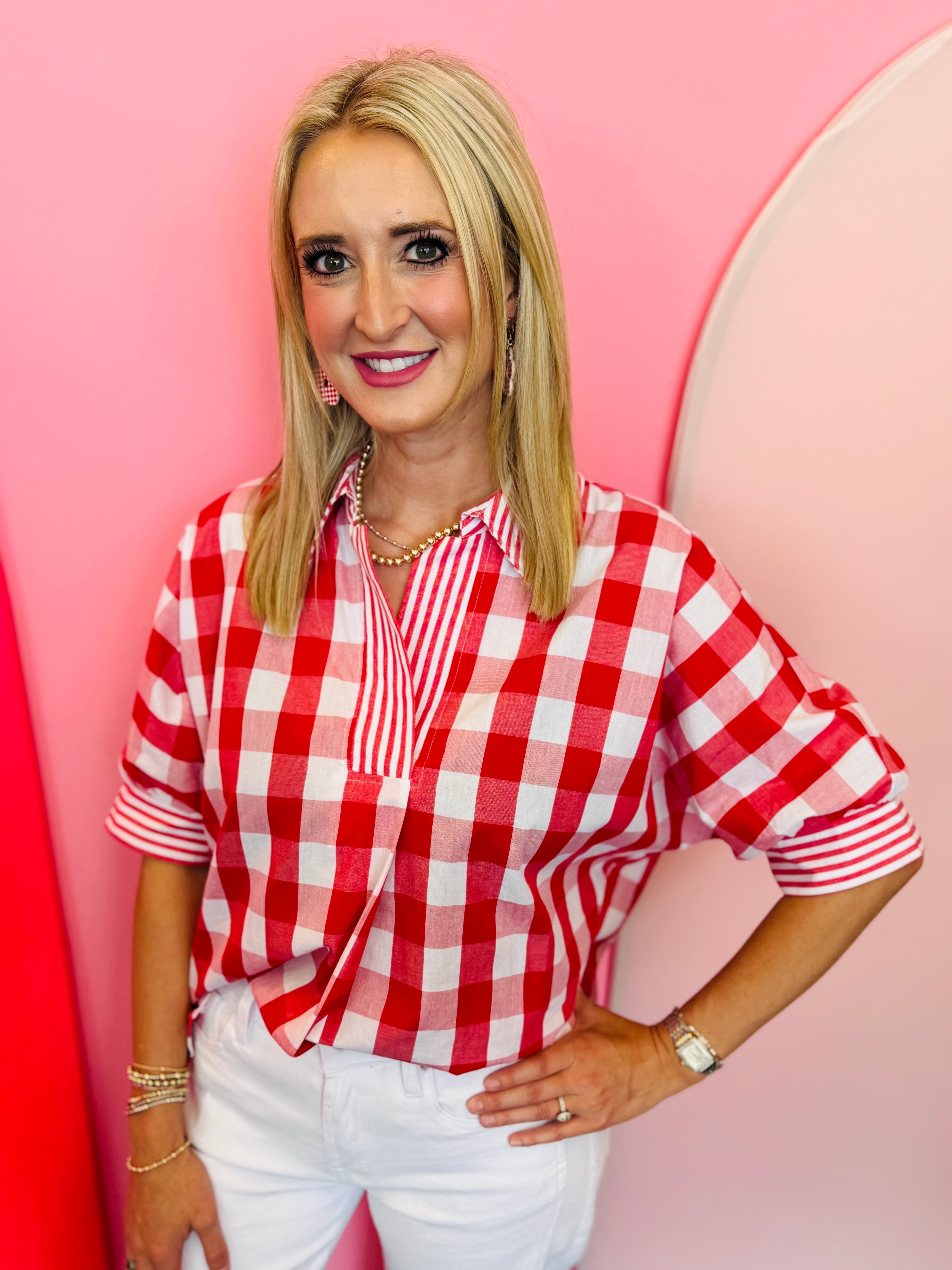 Red and white gingham top with striped collar, rolled sleeves, and hi-low hem.