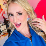 Woman showcasing the blue and white bow stud earrings made by Audra Style