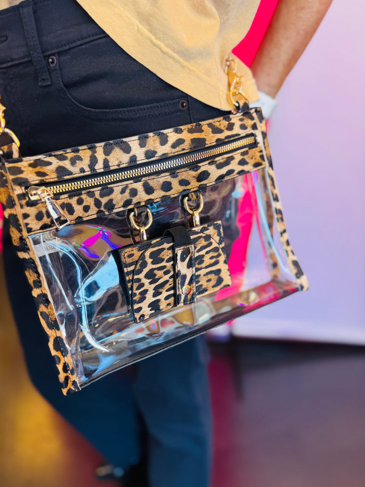 Leopard-trimmed clear crossbody bag with gold hardware and built-in sunglasses holder—stylish, functional, and stadium-ready.