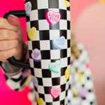 40 oz tumbler with checkered conversation hearts, flip-straw lid, handle, and car cup holder base.