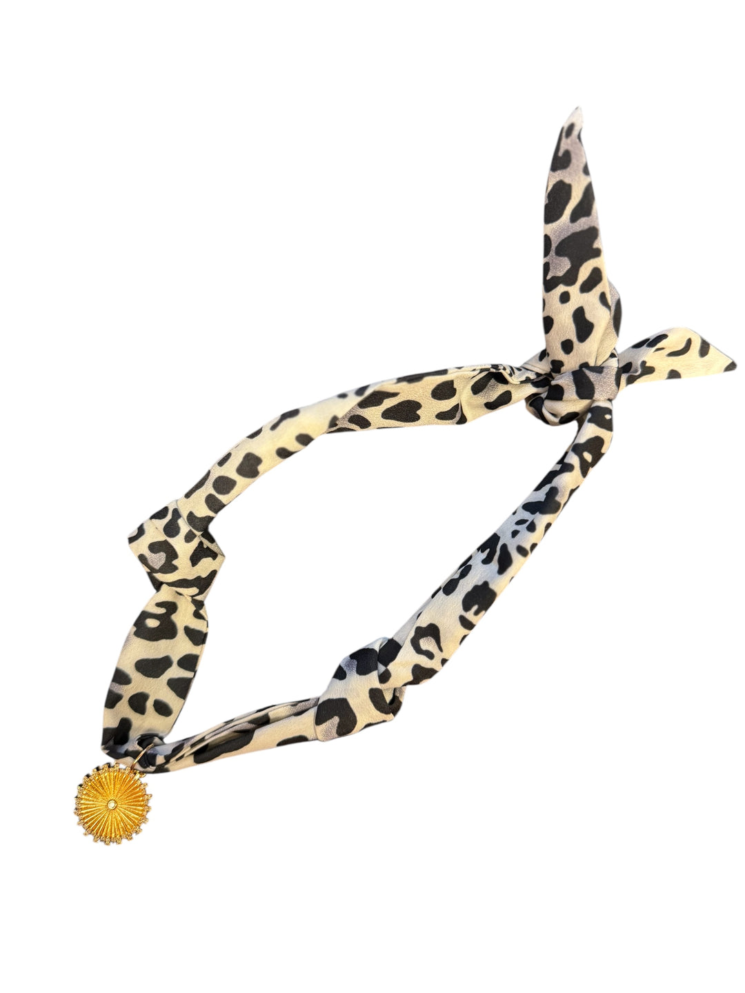 Black and white leopard print satin scarf with gold starburst medallion charm necklace.