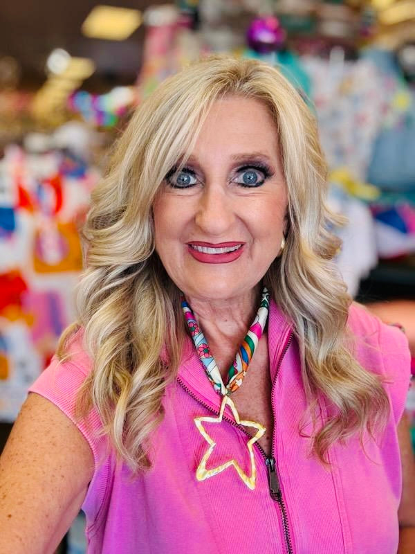 Multicolored retro-print scarf necklace featuring a hammered gold open star charm; vibrant hues of pink, teal, orange, and yellow add a playful, bold touch to any outfit.