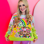Lime green Christmas sweater with sequin gingerbread village, candy canes, nutcrackers, and rainbows.