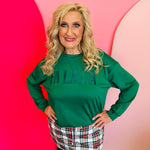 Soft Luxe pullover with velvet “Fa La La” patch design for cozy, festive holiday wear.