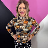 Sheer fall mesh top with orange, black, and cream patterned pumpkins.