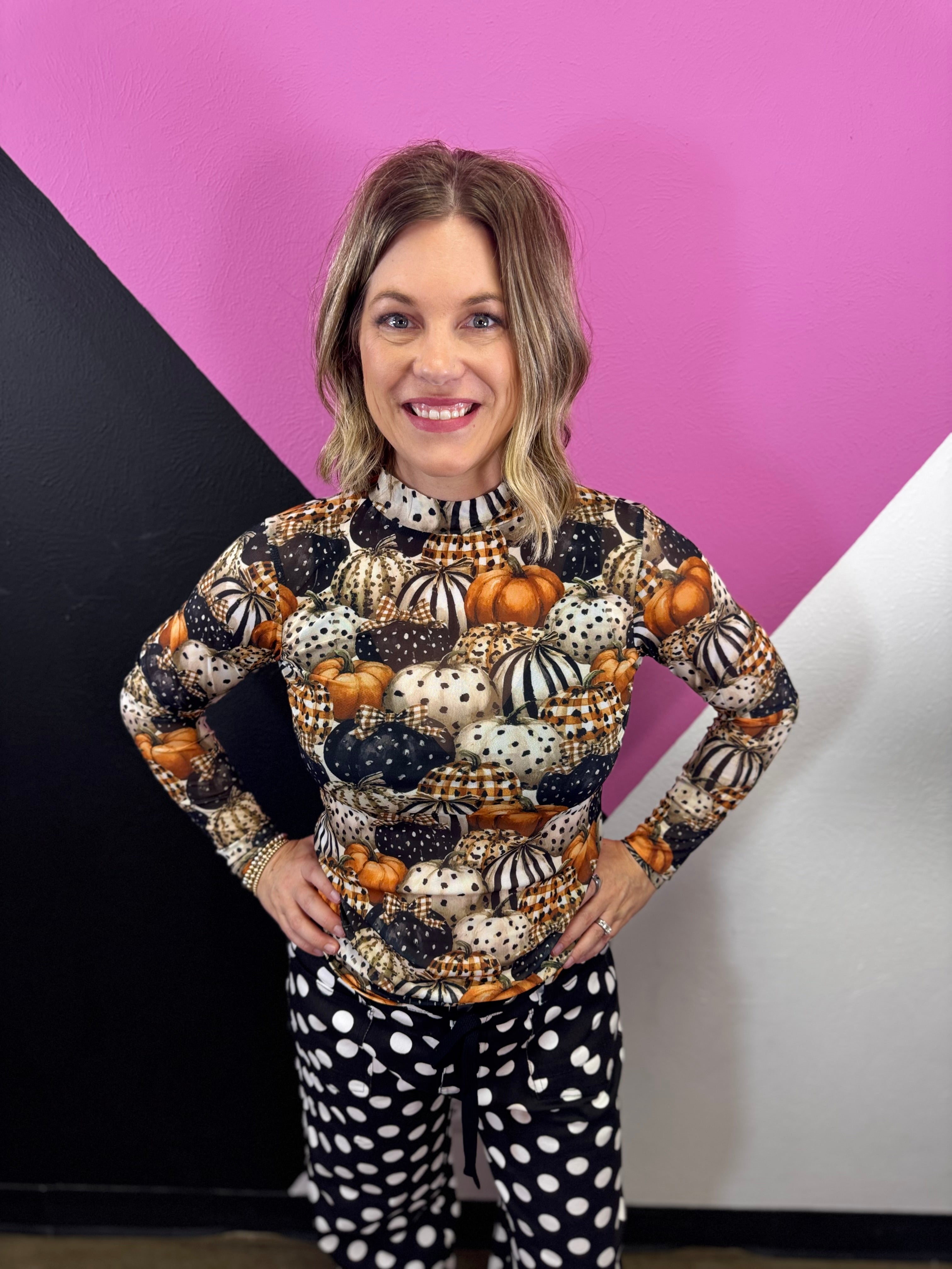 Sheer fall mesh top with orange, black, and cream patterned pumpkins.