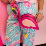 Flamingo crossbody purse with gold chain and zipper closure.