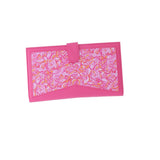 Hot pink wallet with vibrant floral panel and pink snap closure.