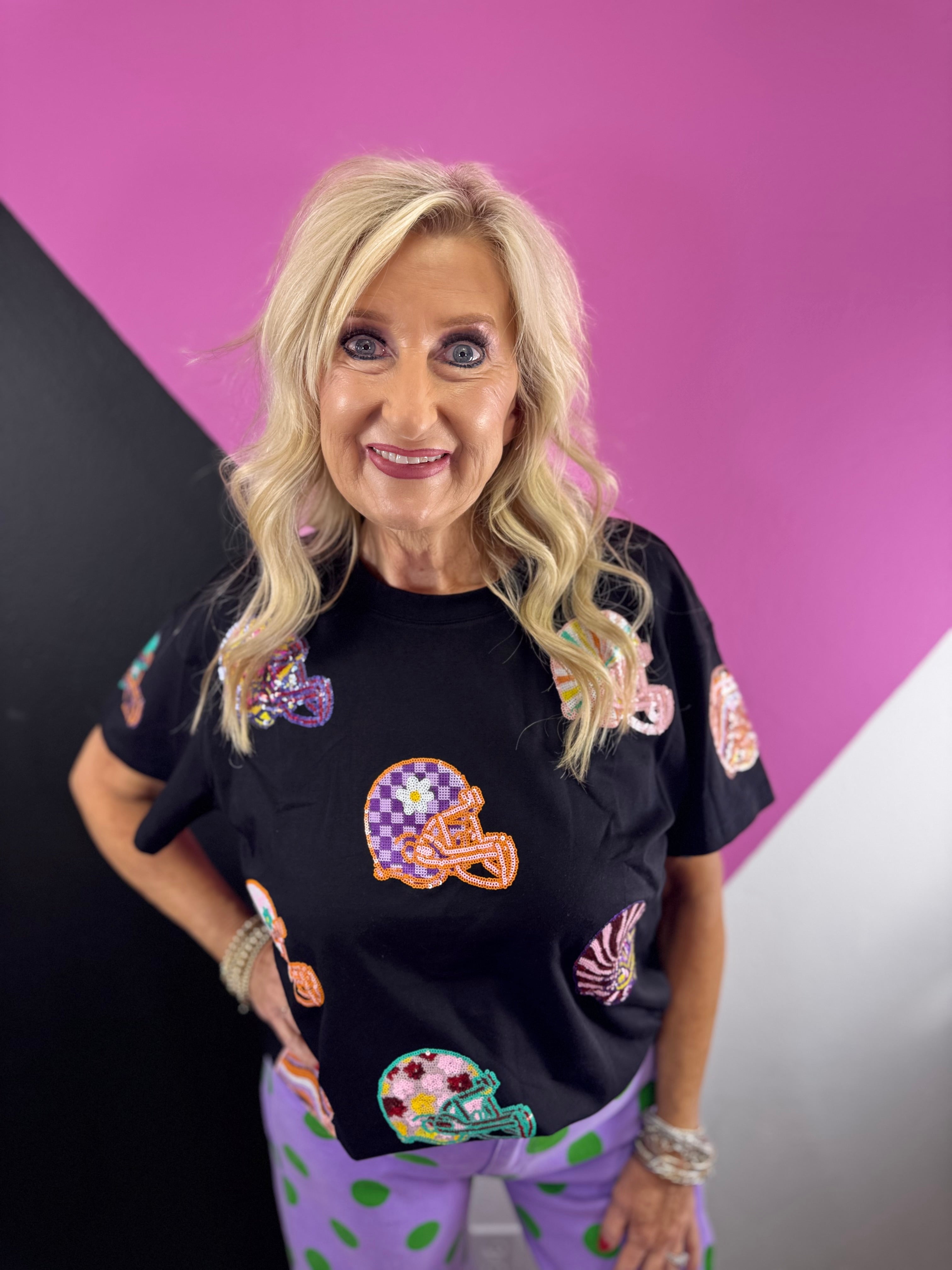 Black game day top with colorful oversized sequin football helmet patches in mixed patterns.