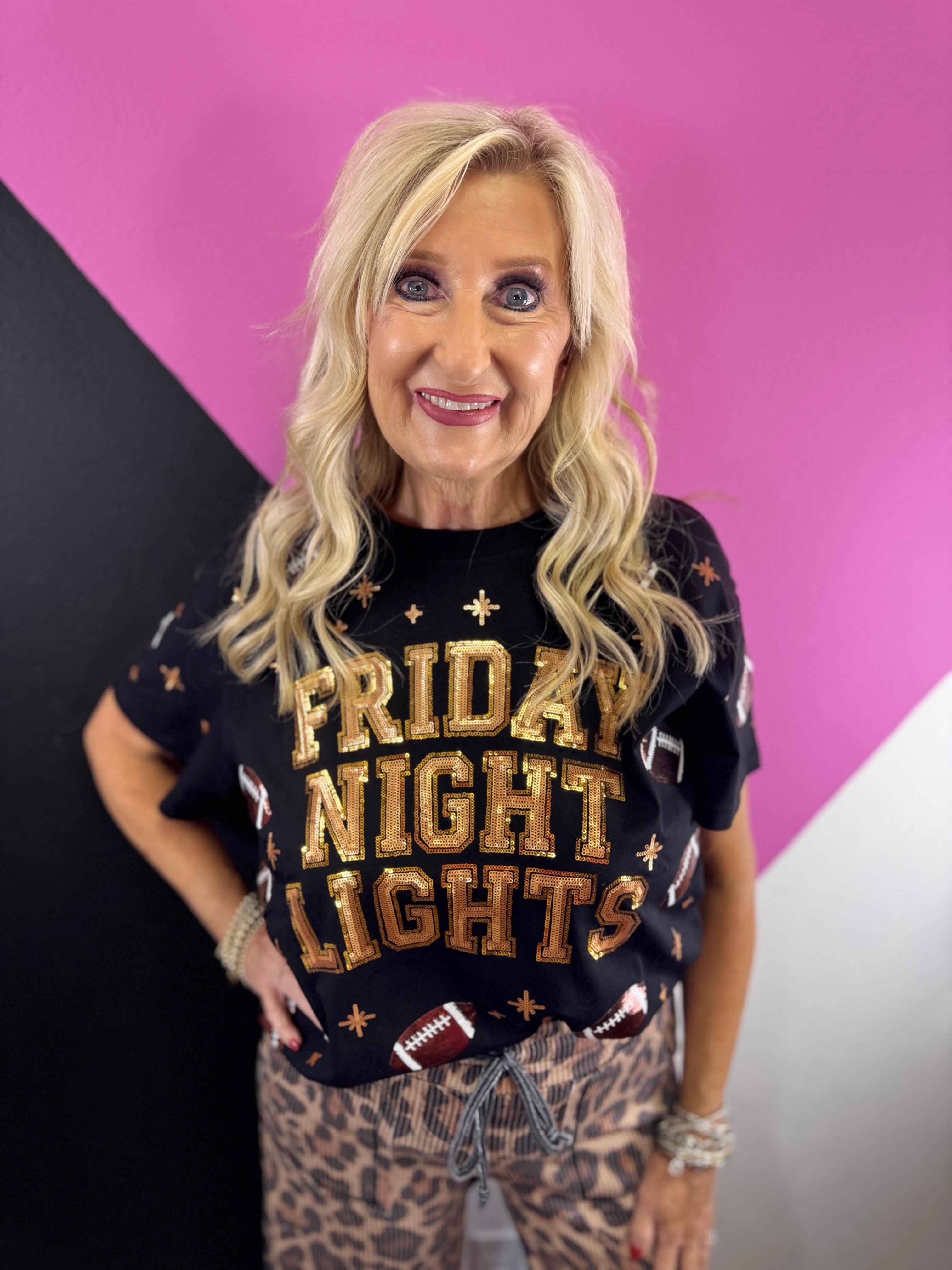 Black game day top with gold sequin Friday Night Lights lettering, footballs, and starbursts.