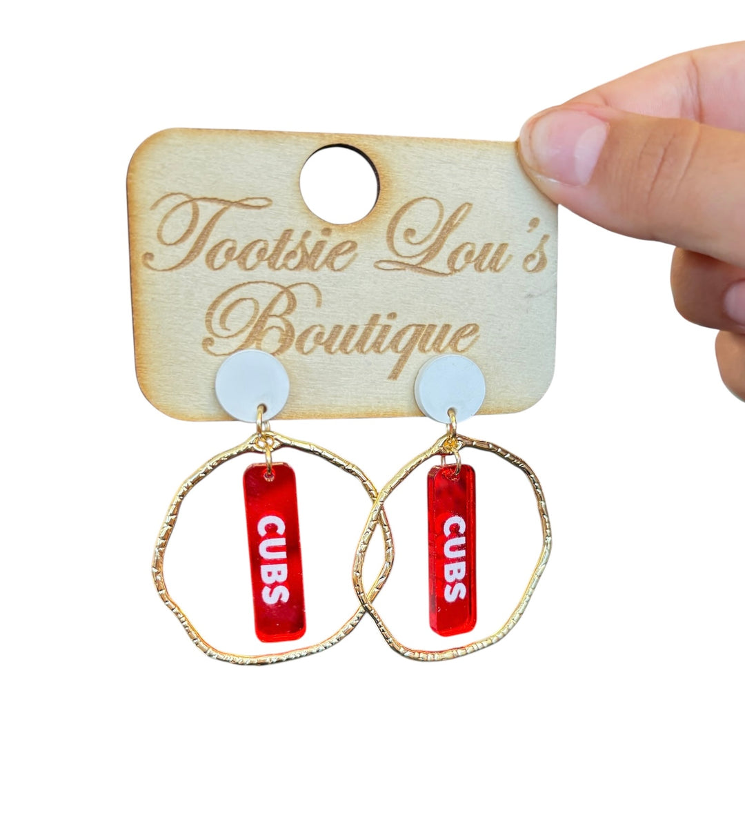 Gold  hoop earrings with red dangles and white writing that says Cubs set on a white stud