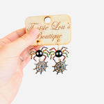 spider dangle earrings, metal colorful spider legs, web hanging down 