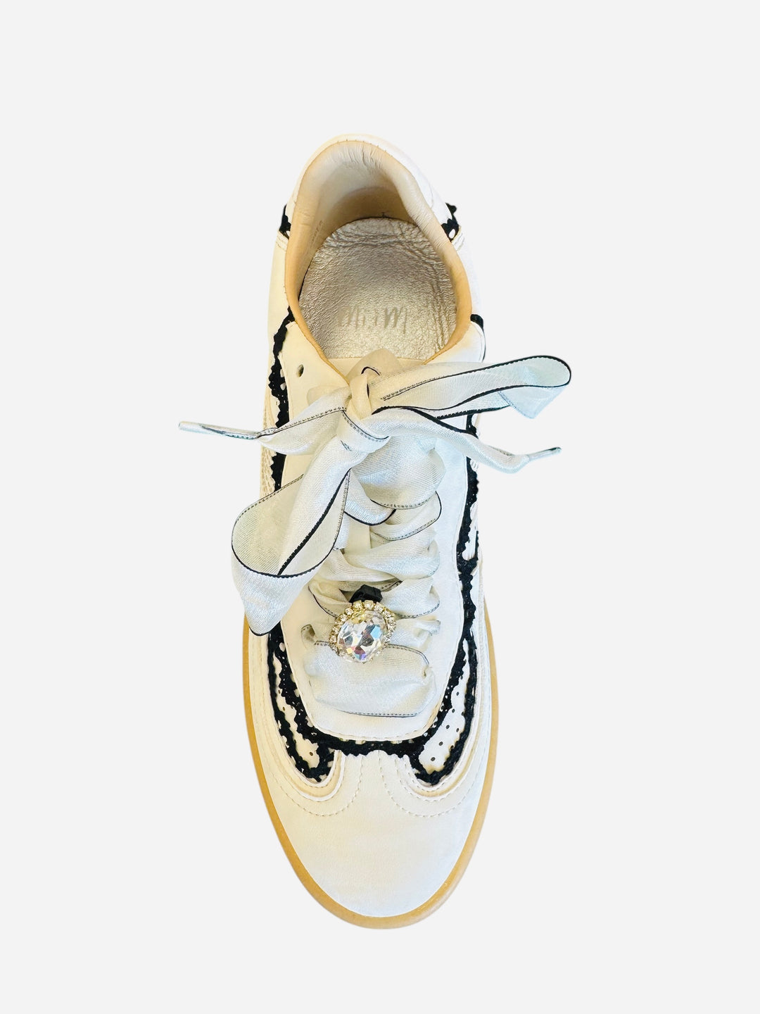 White low-top sneakers with vegan leather upper, delicate lace trim, lace-up closure, and round toe.