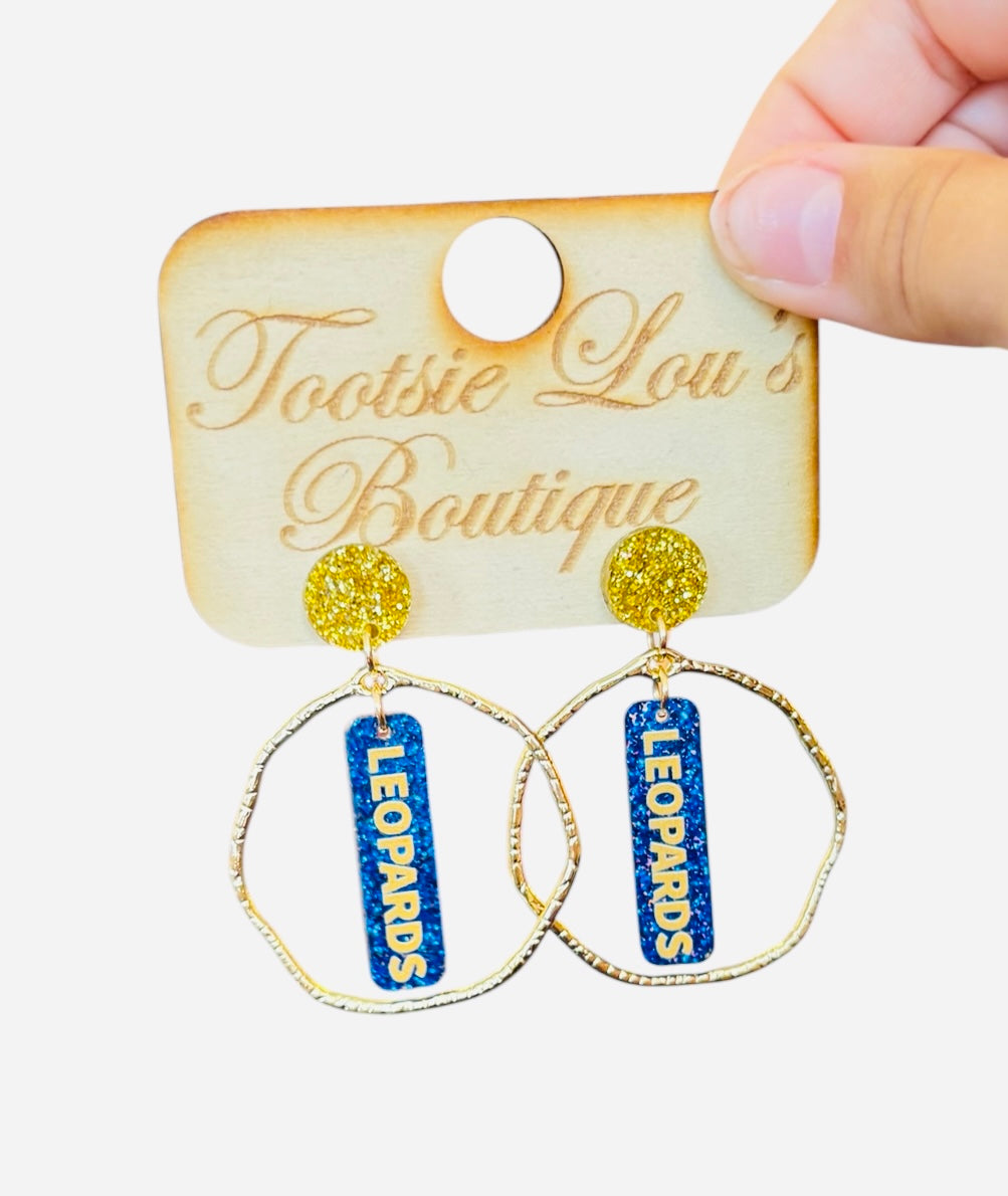 Royal blue acrylic dangles with LEOPARDS in gold font set on gold glitter stud and surrounded by gold hoop.