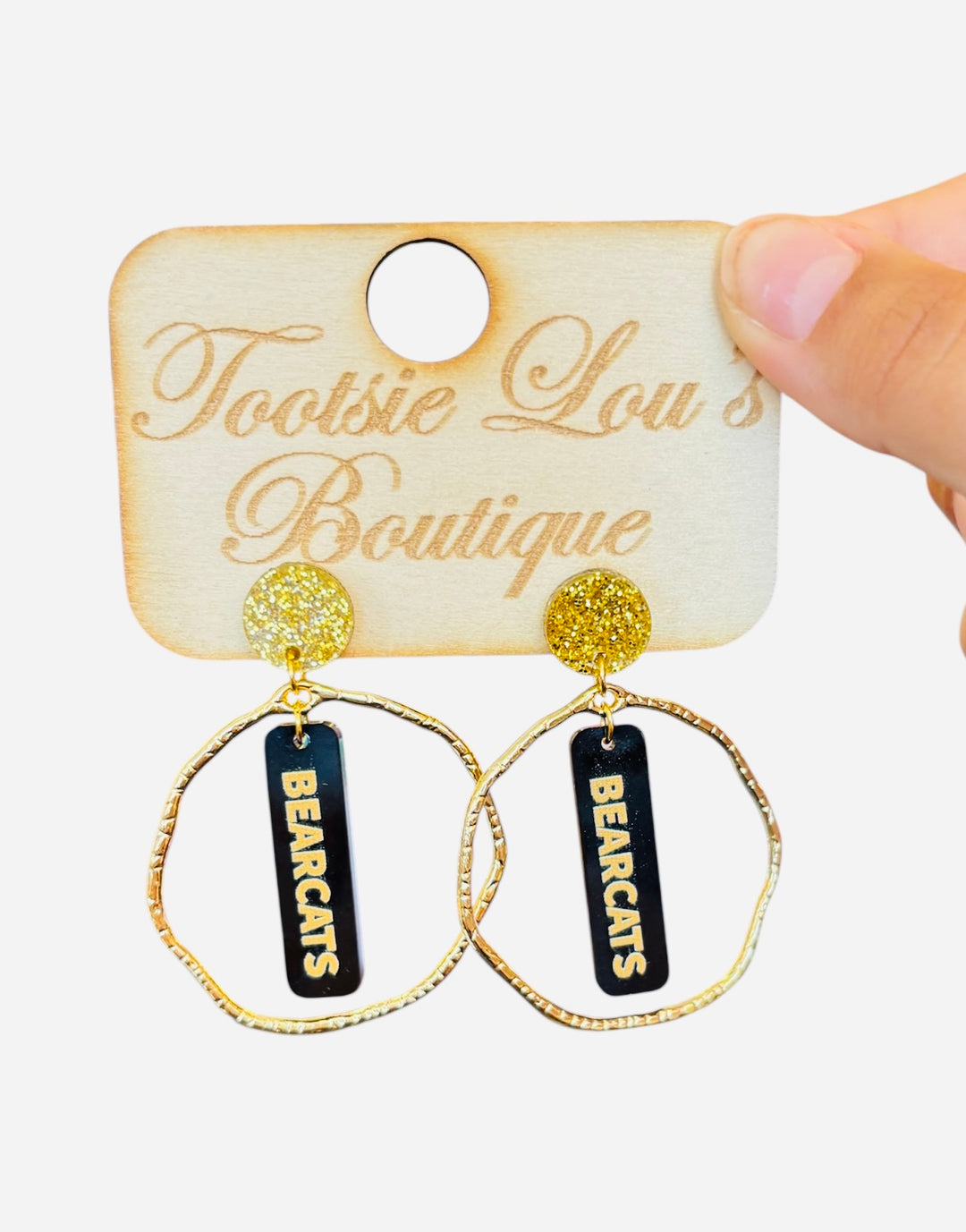 Gold hoops with black dangles and gold writing that says Bearcats set on gold glitter stud