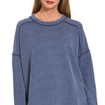 Navy ribbed boat neck top with raw edge detailing, long sleeves, and relaxed fit.
