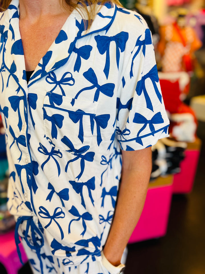 White pajama set with soft blue bow print, featuring a relaxed-fit short-sleeve top 