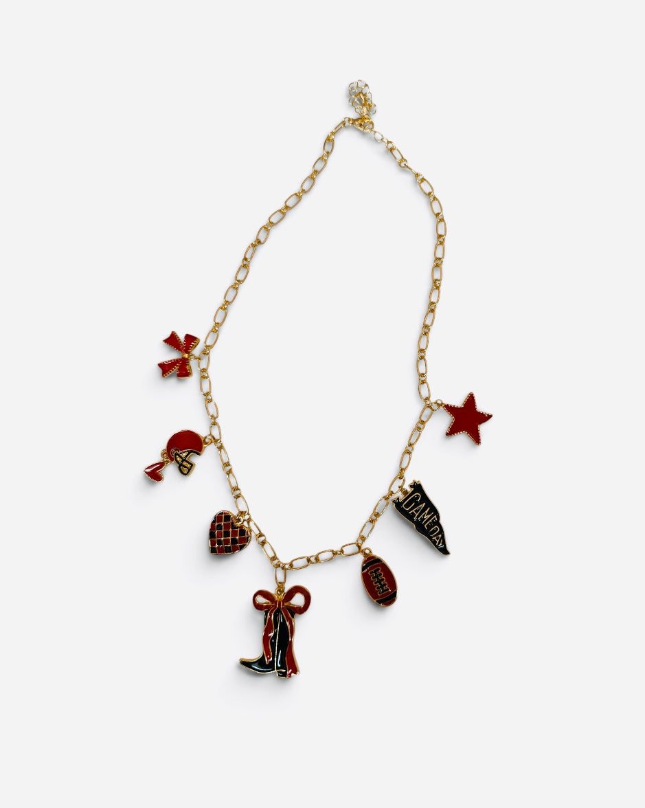 Red and black game day charm necklace with gold-tone chain and football-themed charms.