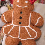 Gingerbread girl pillow with festive details, soft and cozy holiday home accent.